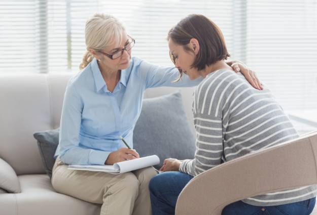 female therapist comforting client