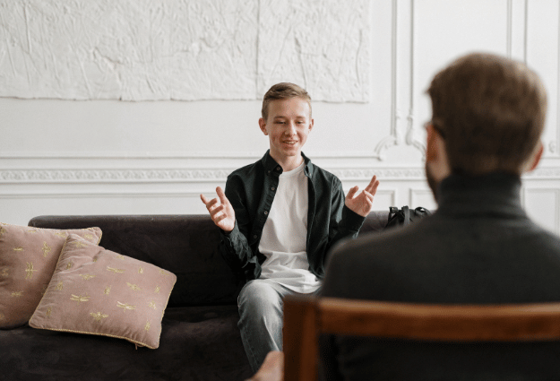 young man speaking to a therapist