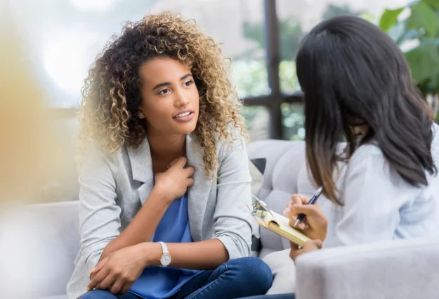 Young woman talking with a mental health professional during a counseling session