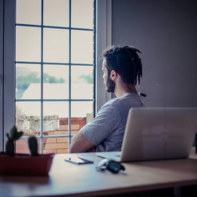 man looking out window door images