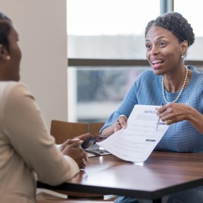 professional woman helping anoher woman