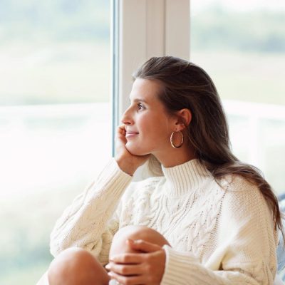 woman smiling looking out window