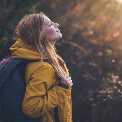 woman smiling on hike in field