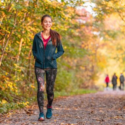 woman smiling walking down trail